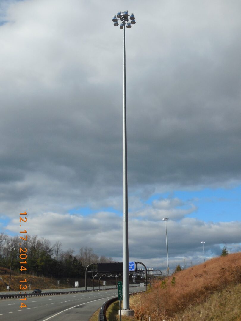 A tall pole with clouds in the background